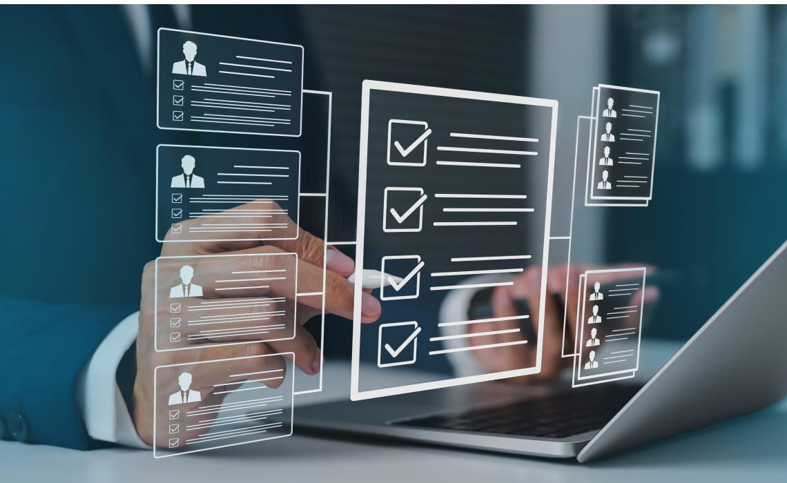 A person in a suit uses a laptop with virtual checklists and profiles floating above. The scene conveys technology, organization, and efficiency.